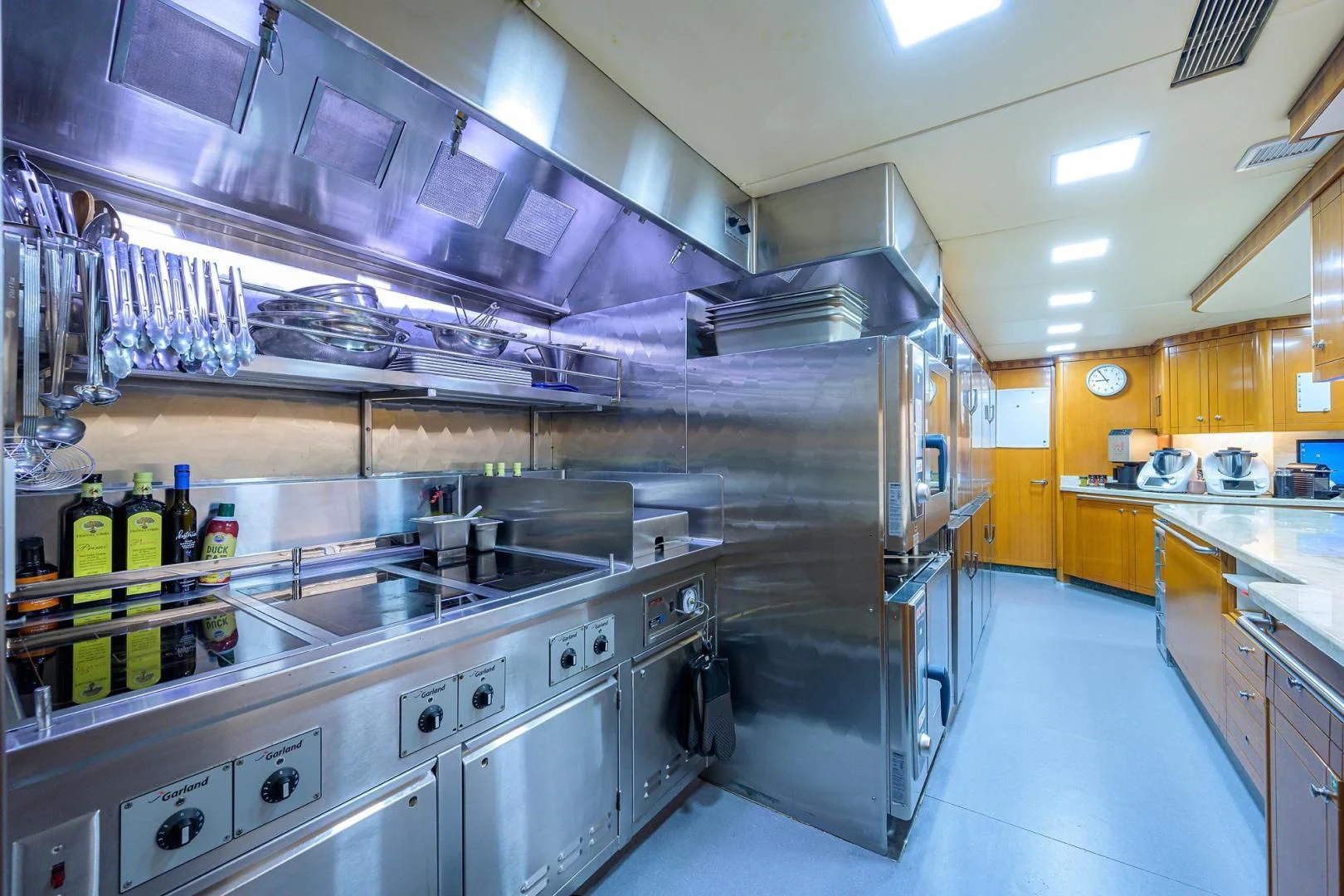 a large kitchen with stainless steel appliances aboard STARSHIP Yacht for Charter