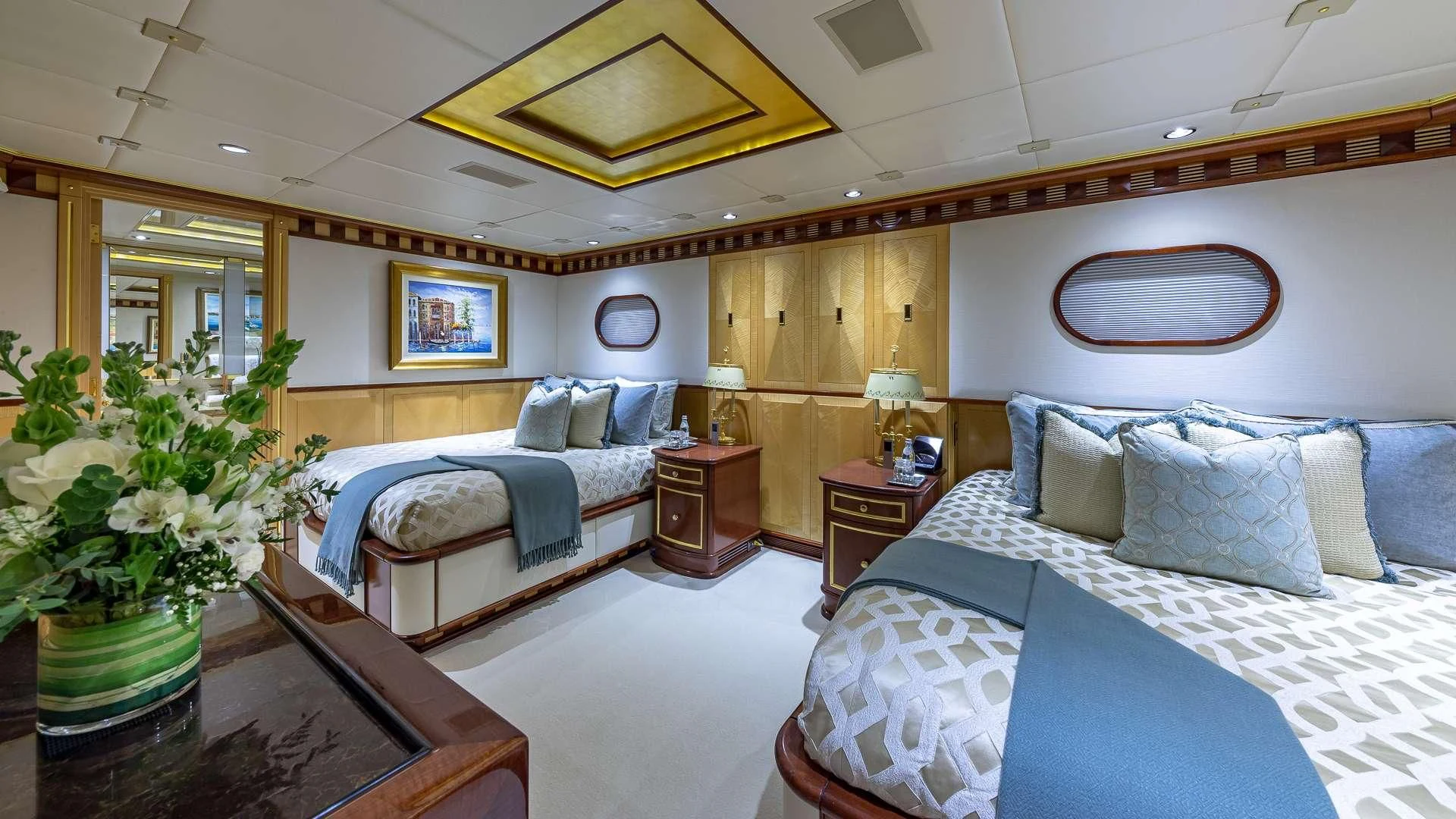 a room with a bed and a plant aboard STARSHIP Yacht for Charter
