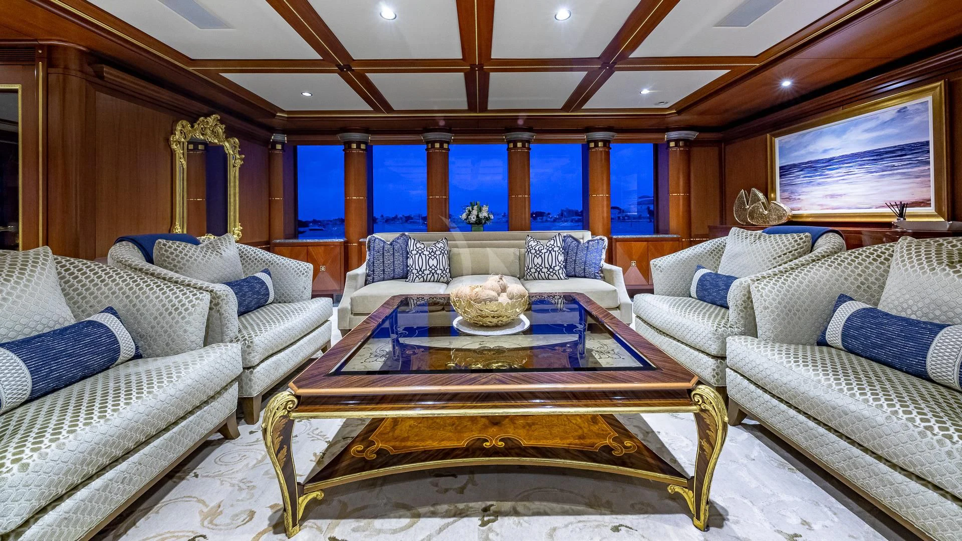 a living room with a table and couches aboard STARSHIP Yacht for Charter