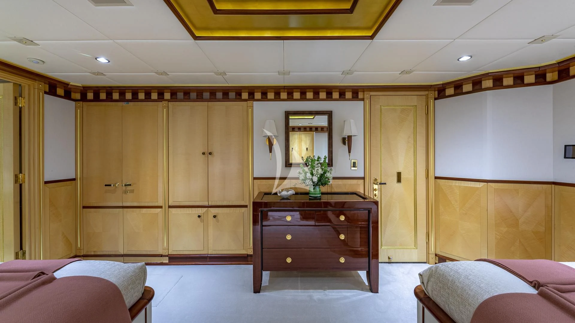 a room with a desk and bed aboard STARSHIP Yacht for Charter