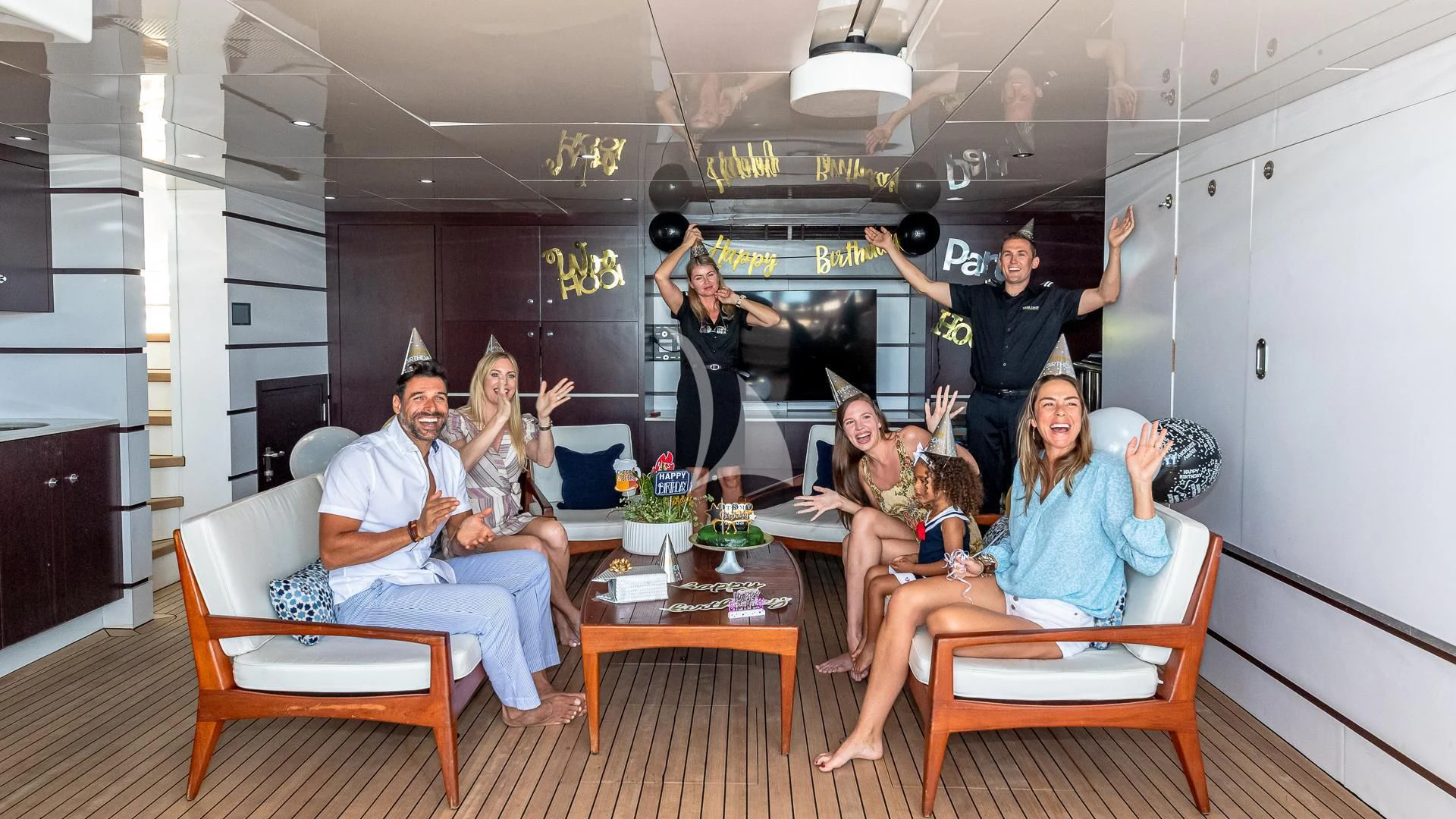 a group of people sitting around a table aboard STARSHIP Yacht for Charter