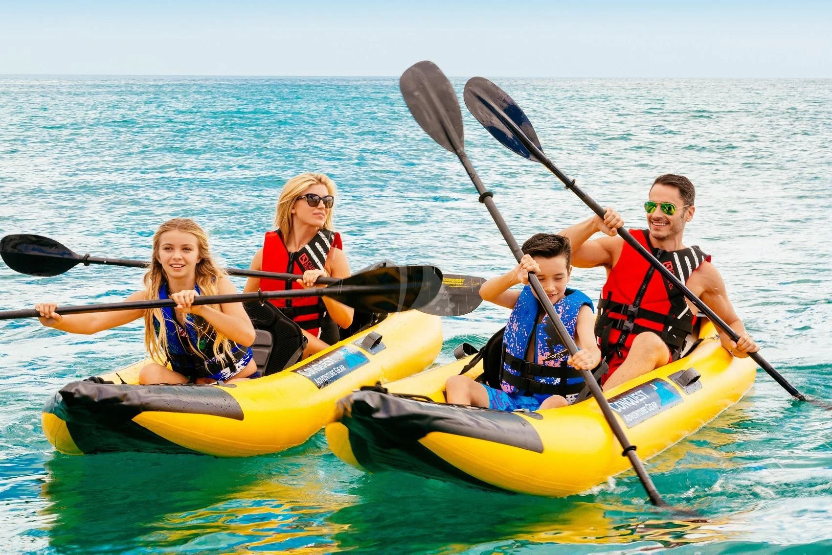 a group of people in a row on a yellow kayak aboard STARSHIP Yacht for Charter