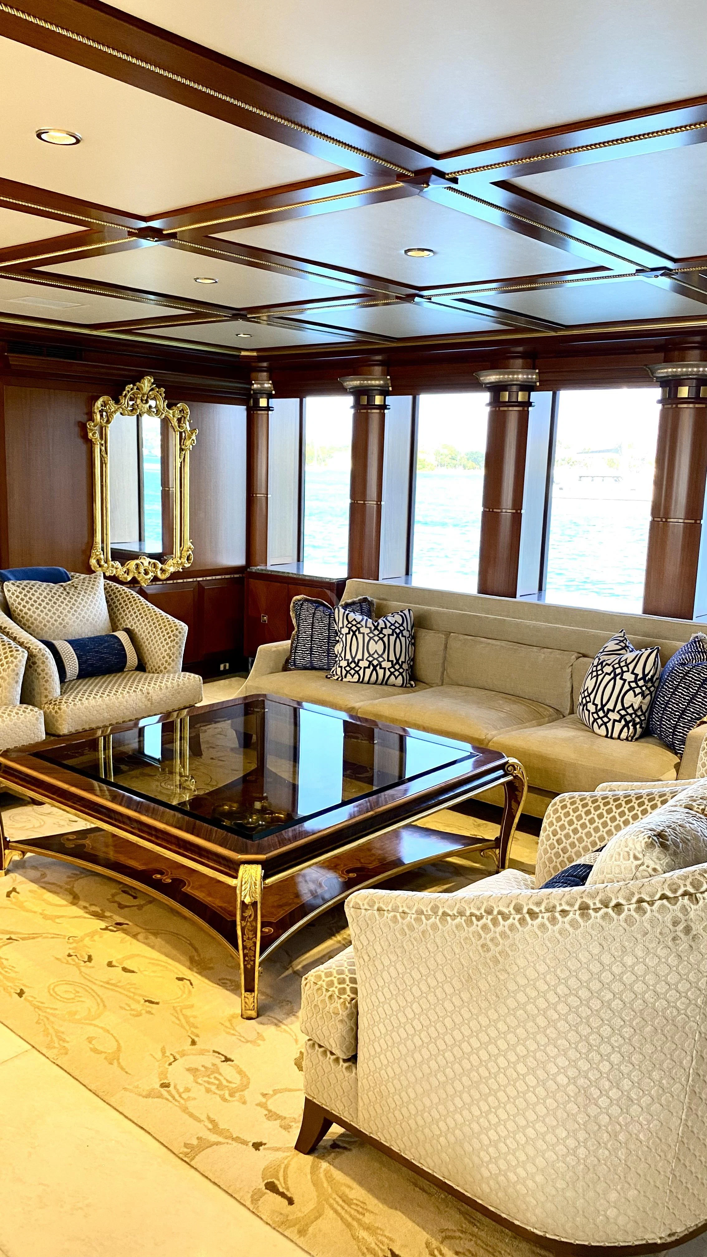 a living room with a table and chairs aboard STARSHIP Yacht for Charter