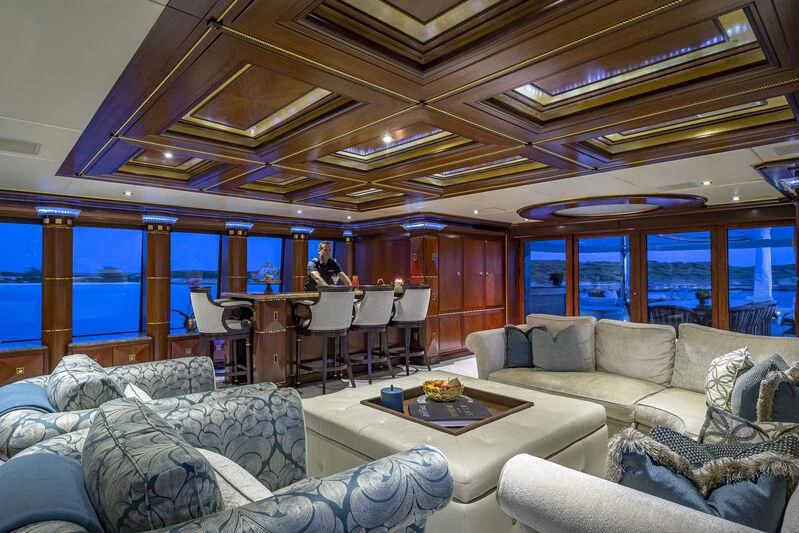 a living room with a large window aboard STARSHIP Yacht for Charter