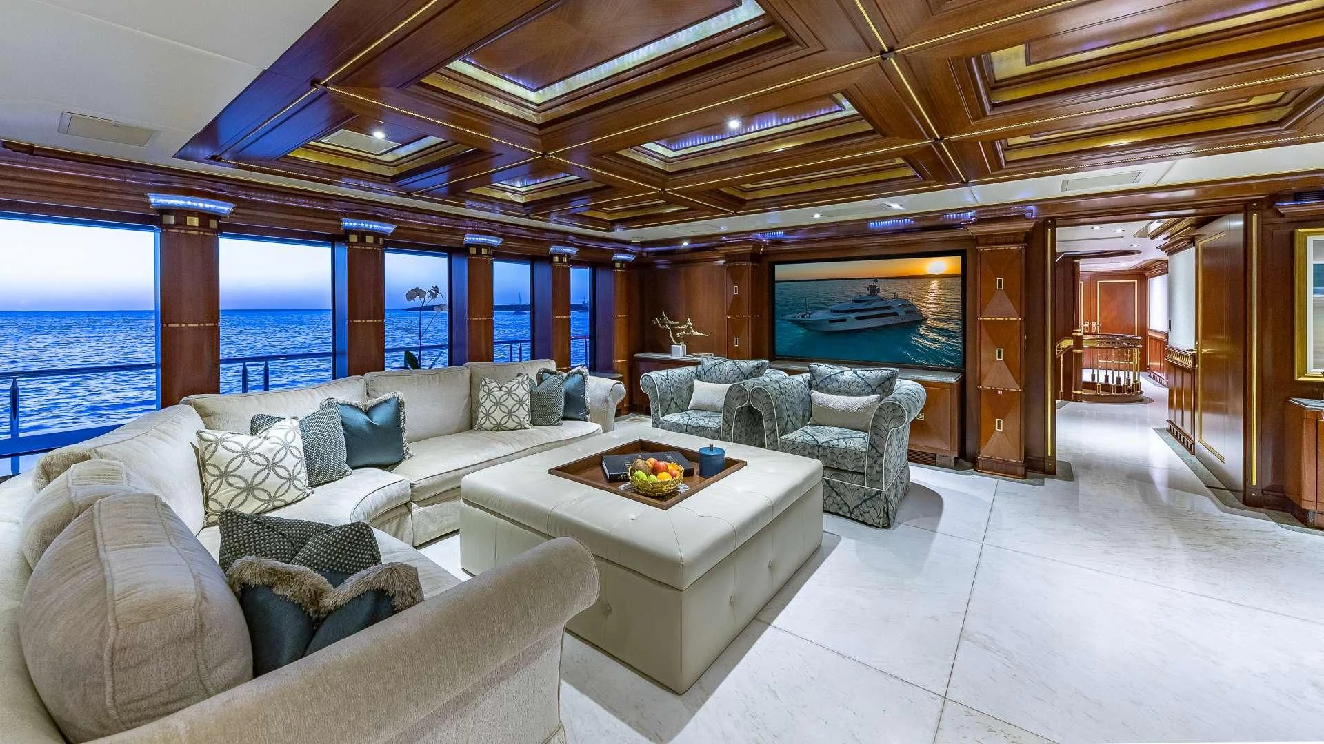 a living room with a large window aboard STARSHIP Yacht for Charter