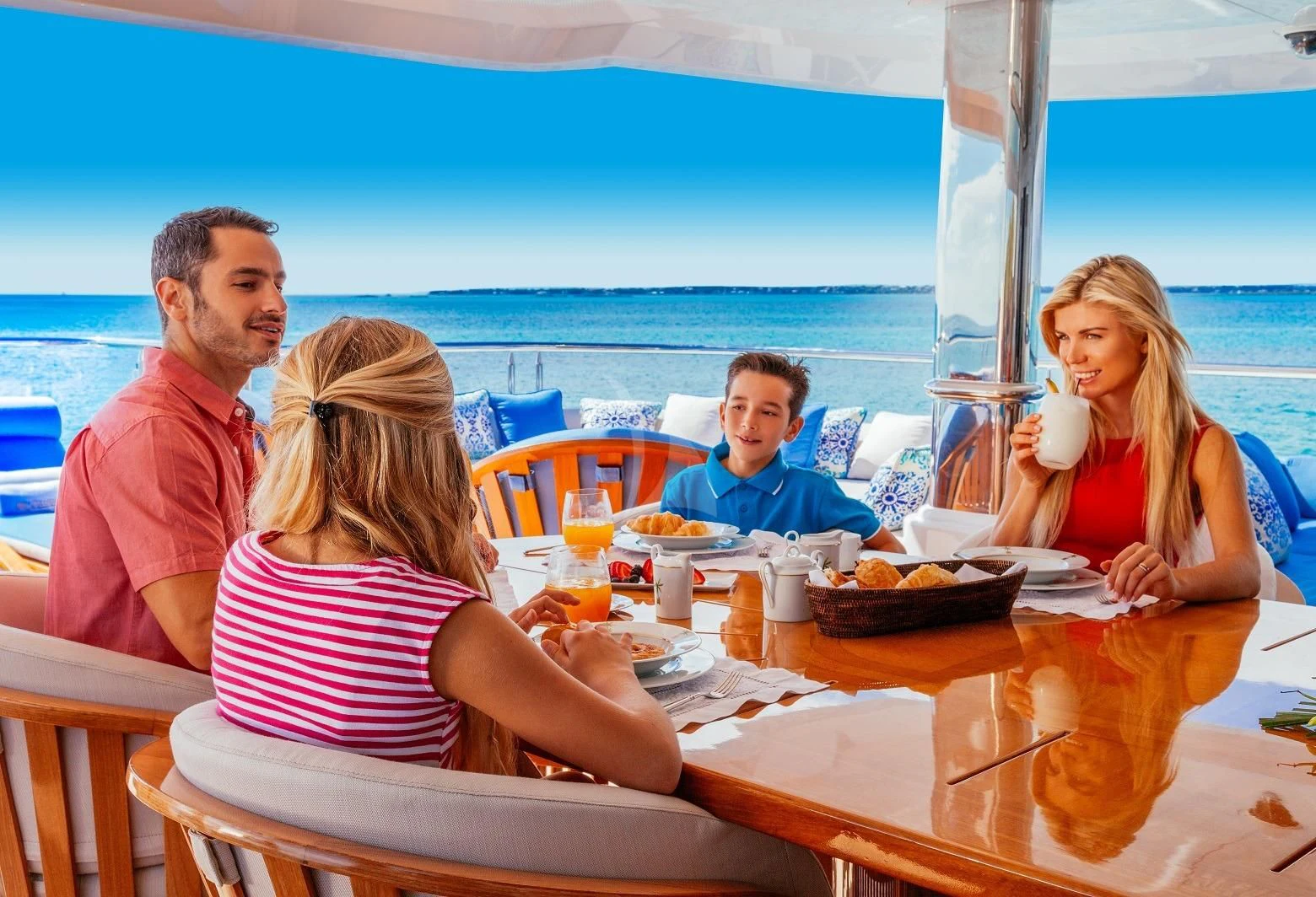 a family eating at a table aboard STARSHIP Yacht for Charter
