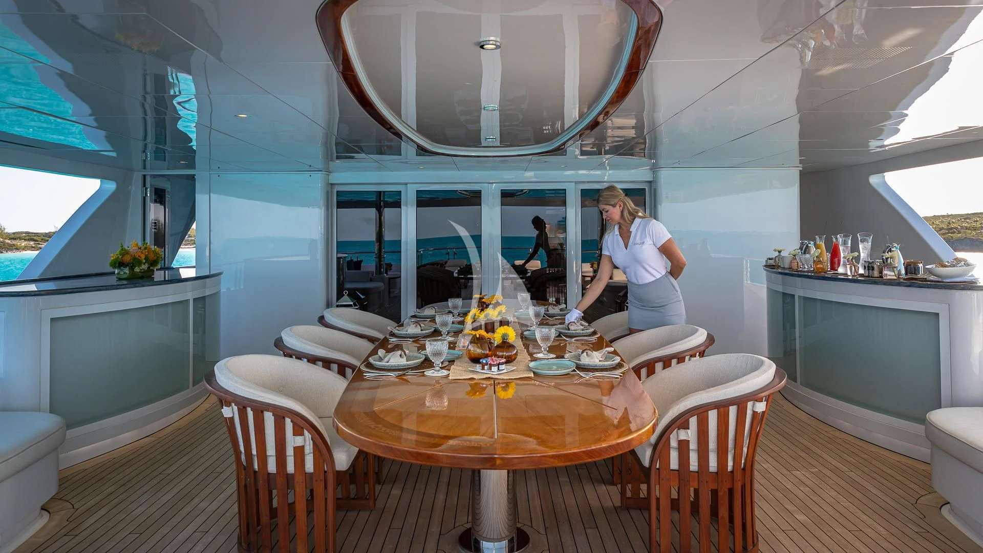 a person sitting at a table in a dining room aboard STARSHIP Yacht for Charter