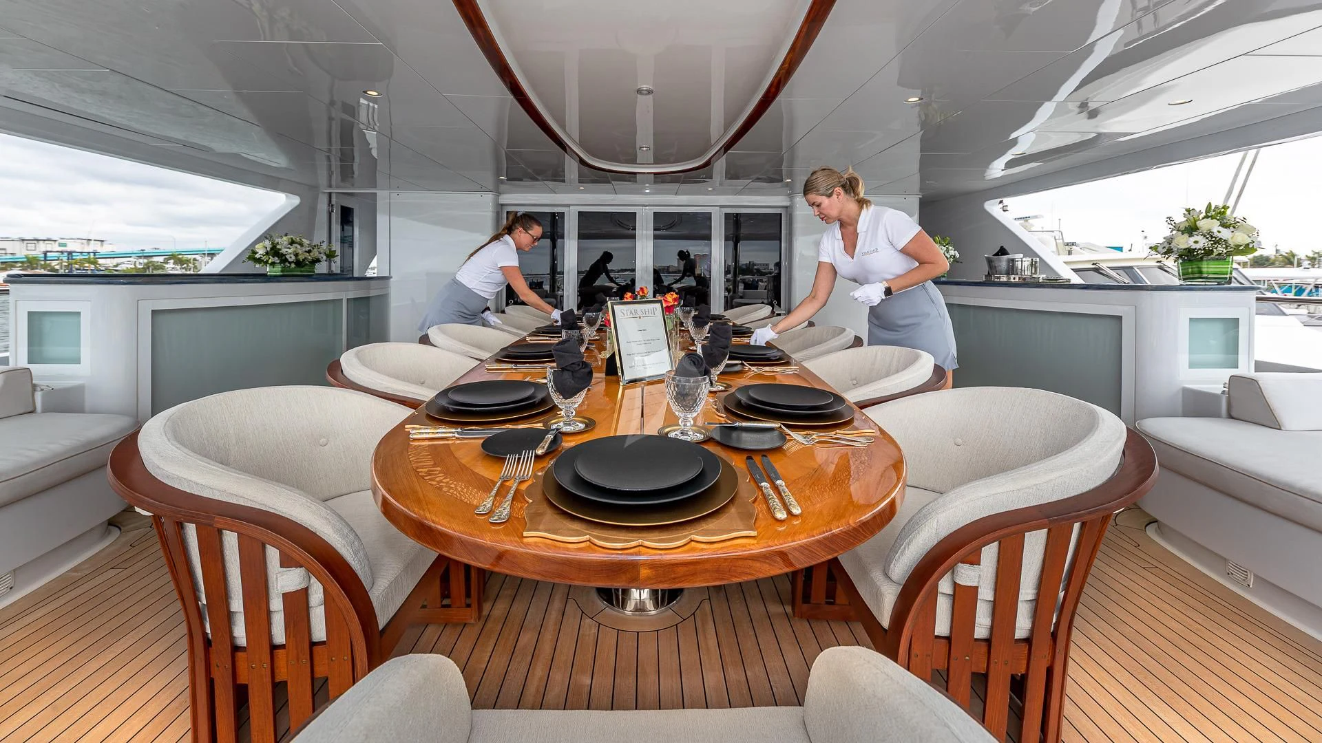 a couple of people sitting at a table in a dining room aboard STARSHIP Yacht for Charter