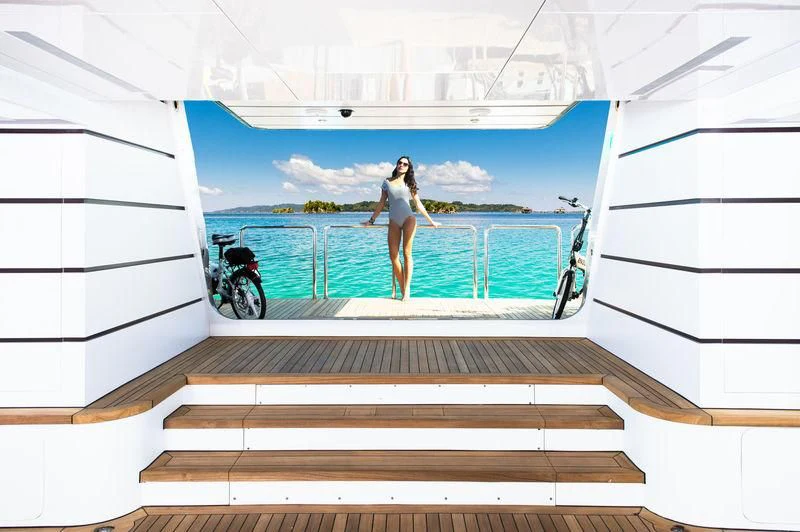 a person standing on a staircase aboard STARSHIP Yacht for Charter