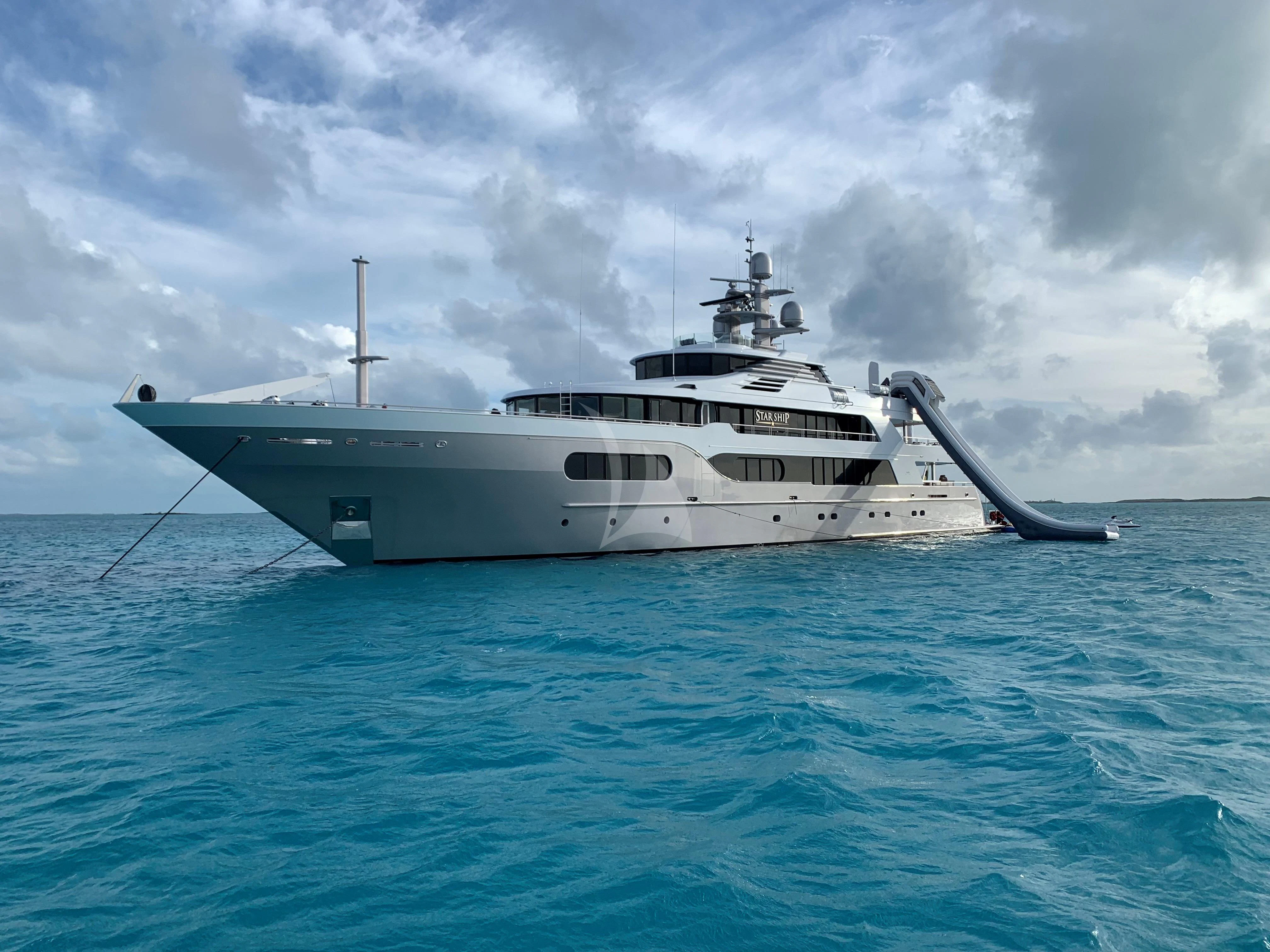 a large white boat in the water aboard STARSHIP Yacht for Charter