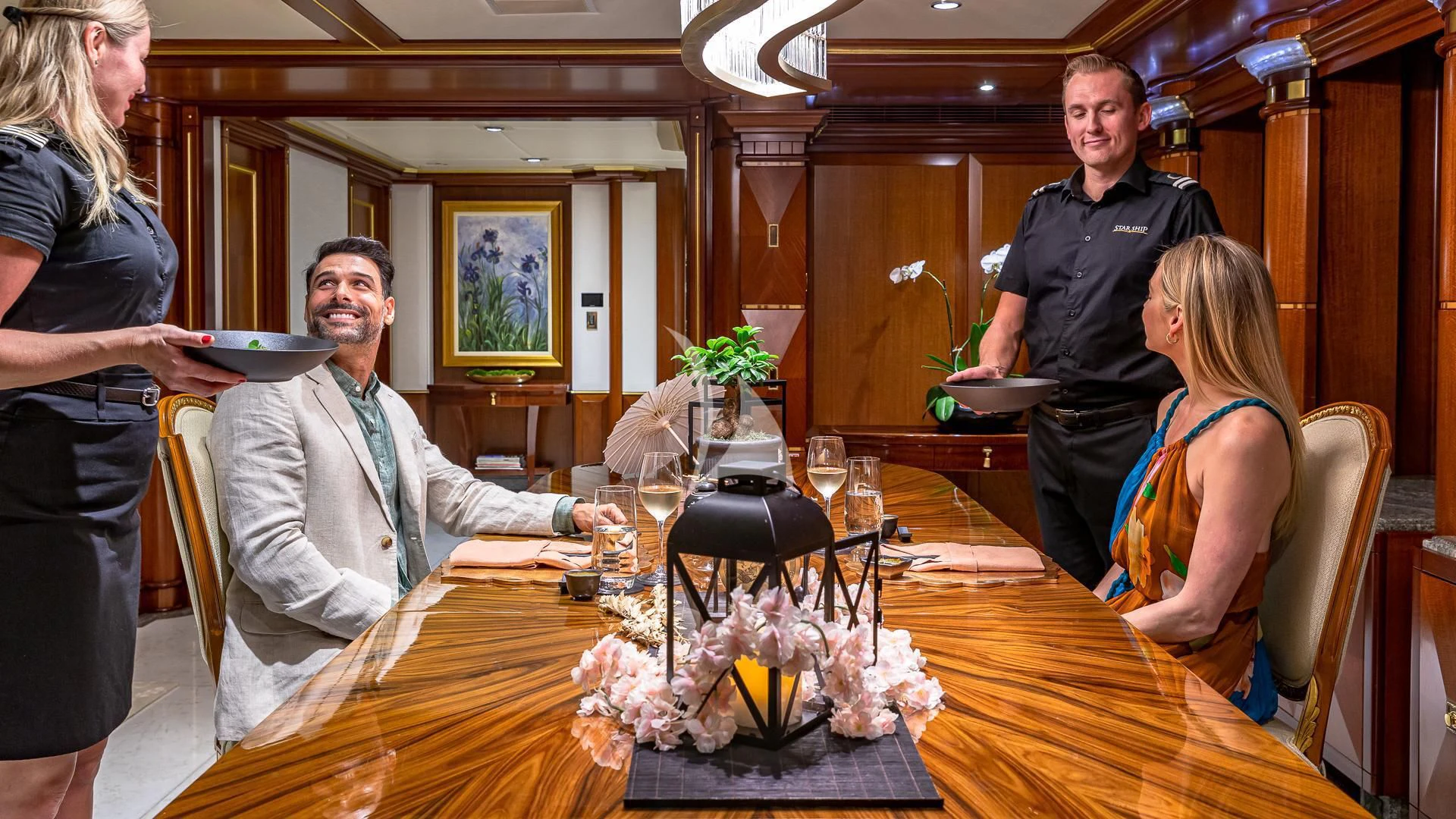 a group of people around a table aboard STARSHIP Yacht for Charter