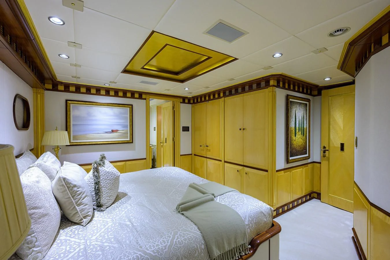 a room with a bed and a desk aboard STARSHIP Yacht for Charter