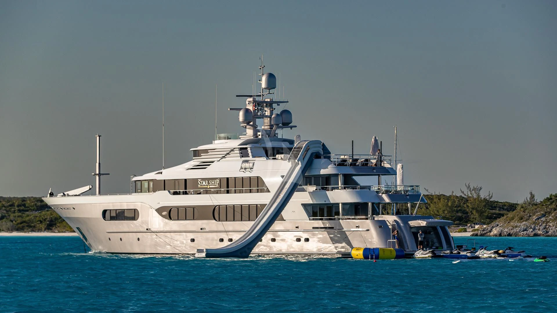 a large white boat in the water aboard STARSHIP Yacht for Charter