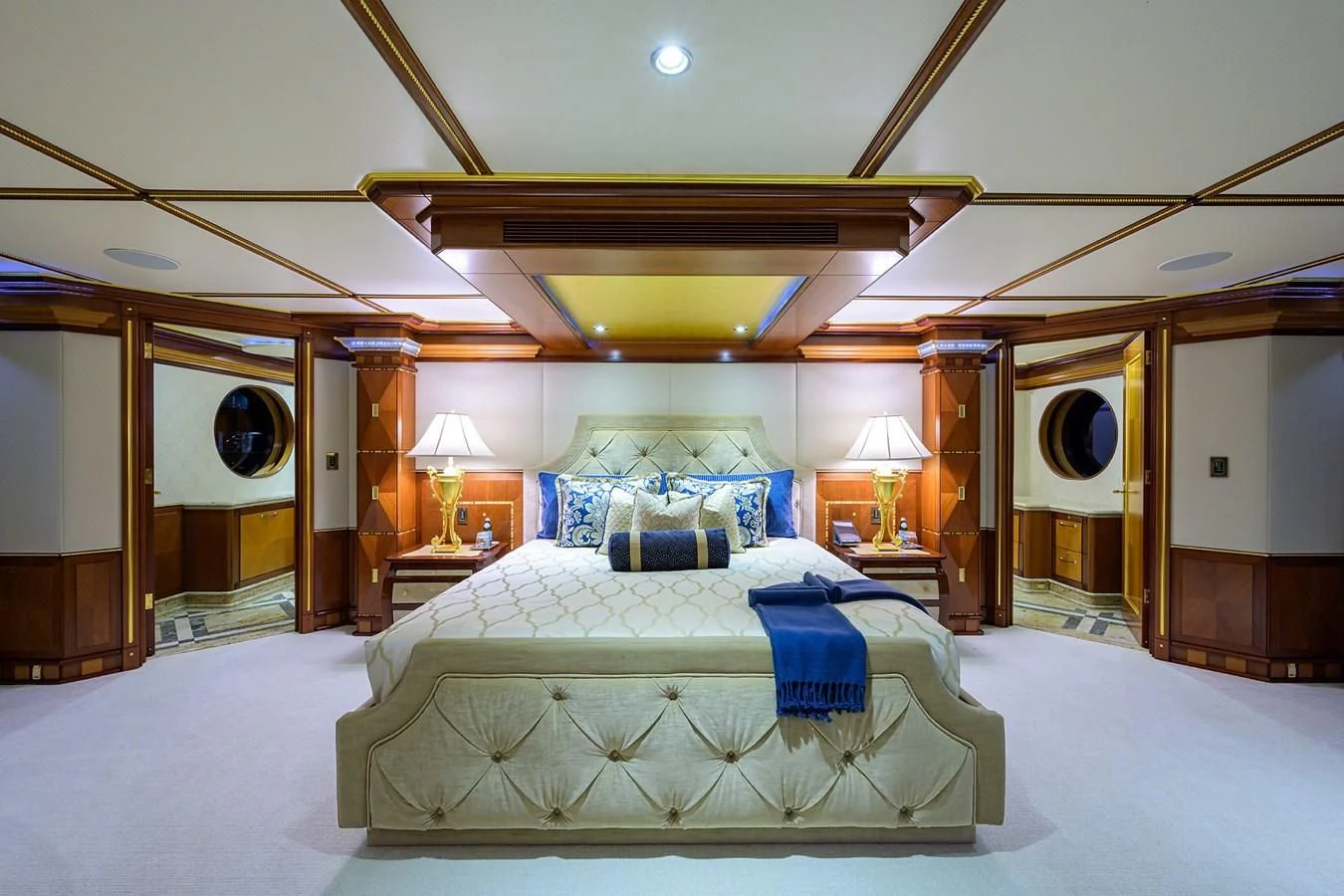 a room with a bed and a mirror aboard STARSHIP Yacht for Charter