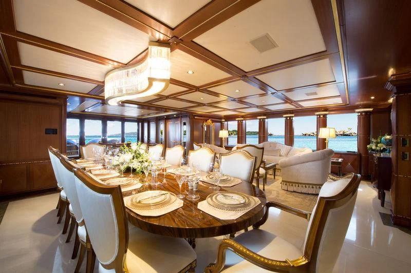 a room with tables and chairs aboard STARSHIP Yacht for Charter