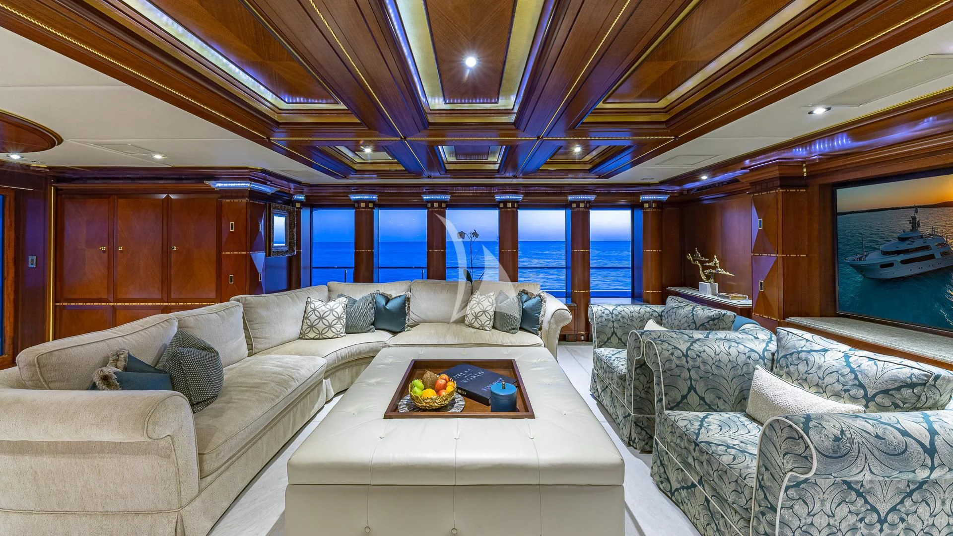 a living room with a large window aboard STARSHIP Yacht for Charter