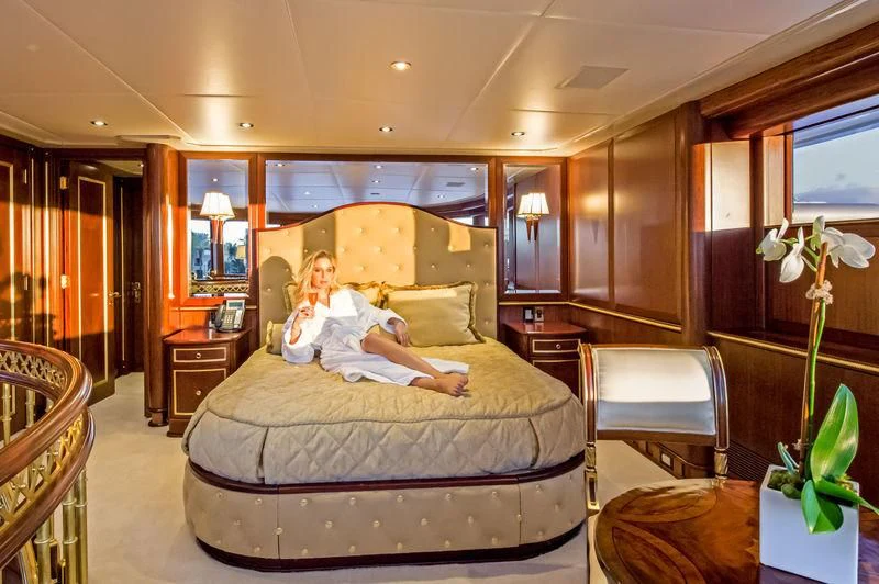 a couple of people sitting on a bed in a room aboard STARSHIP Yacht for Charter