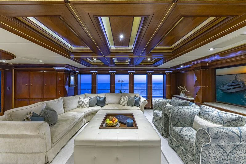 a living room with a large window aboard STARSHIP Yacht for Charter