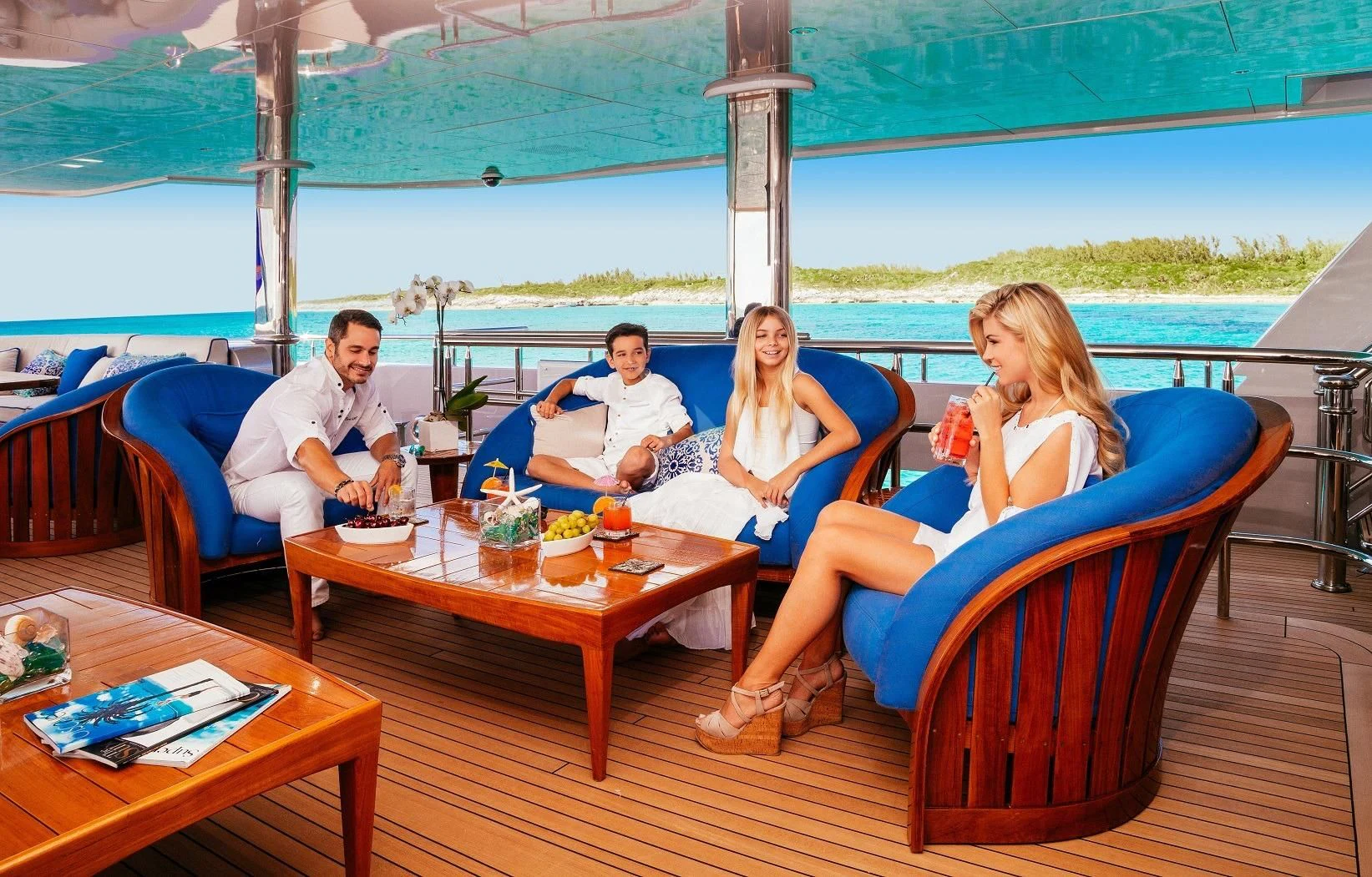 a group of people sitting around a table on a boat aboard STARSHIP Yacht for Charter