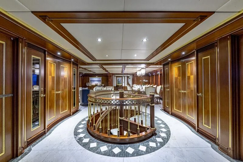 a large room with a table and chairs aboard STARSHIP Yacht for Charter