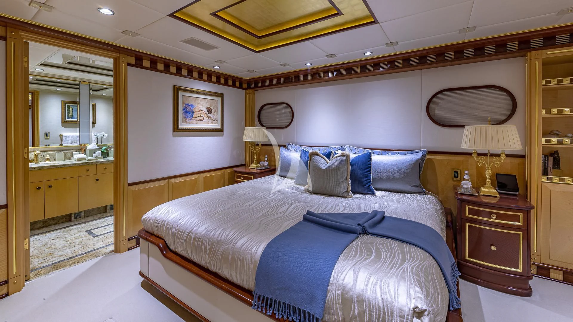 a bedroom with a bed and a desk aboard STARSHIP Yacht for Charter