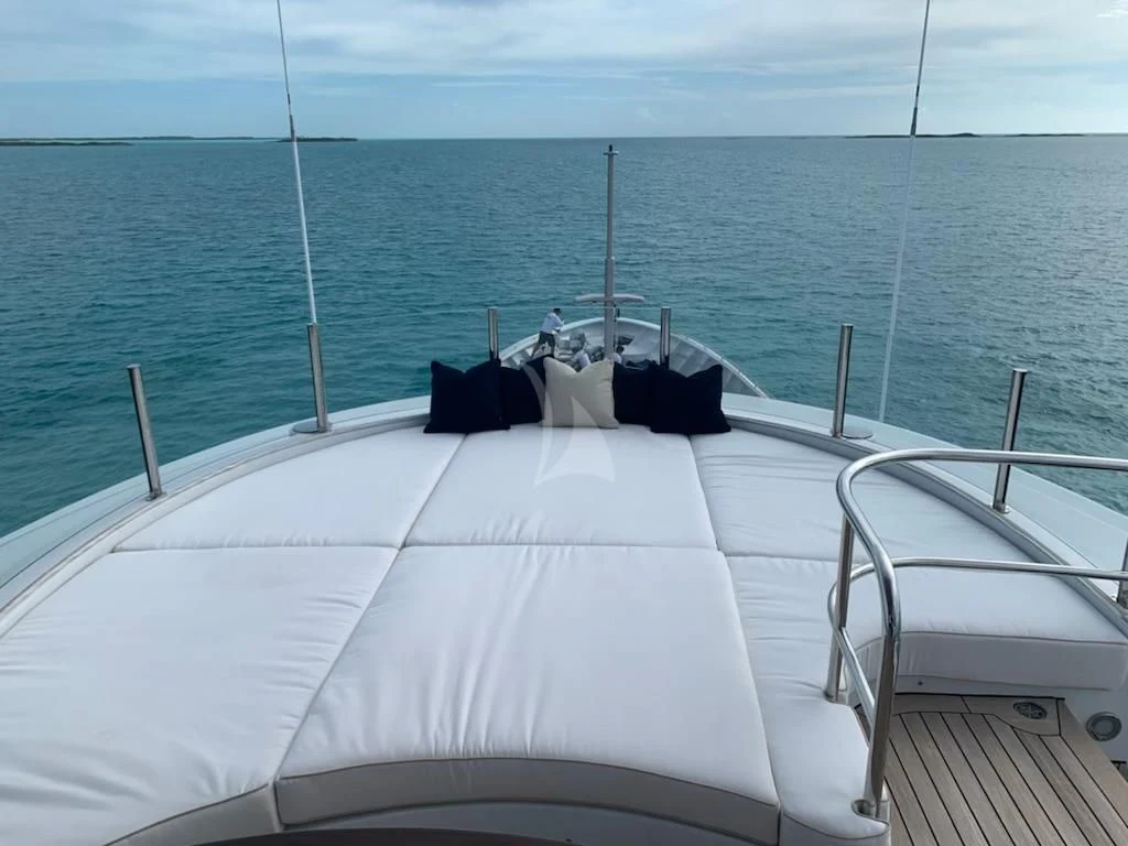 a boat with white seats on a deck overlooking the ocean aboard STARSHIP Yacht for Charter