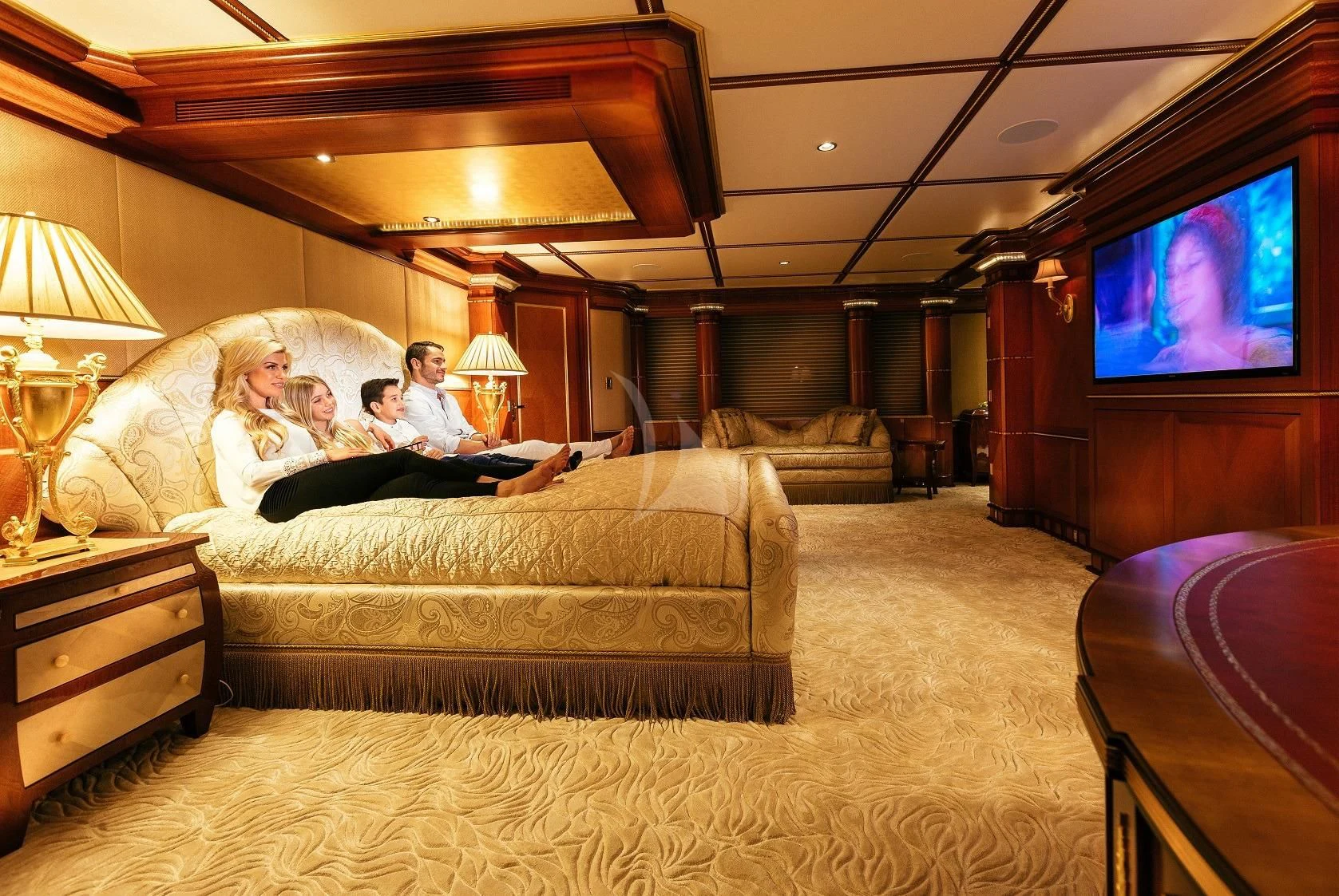 a couple of people on a couch watching television aboard STARSHIP Yacht for Charter