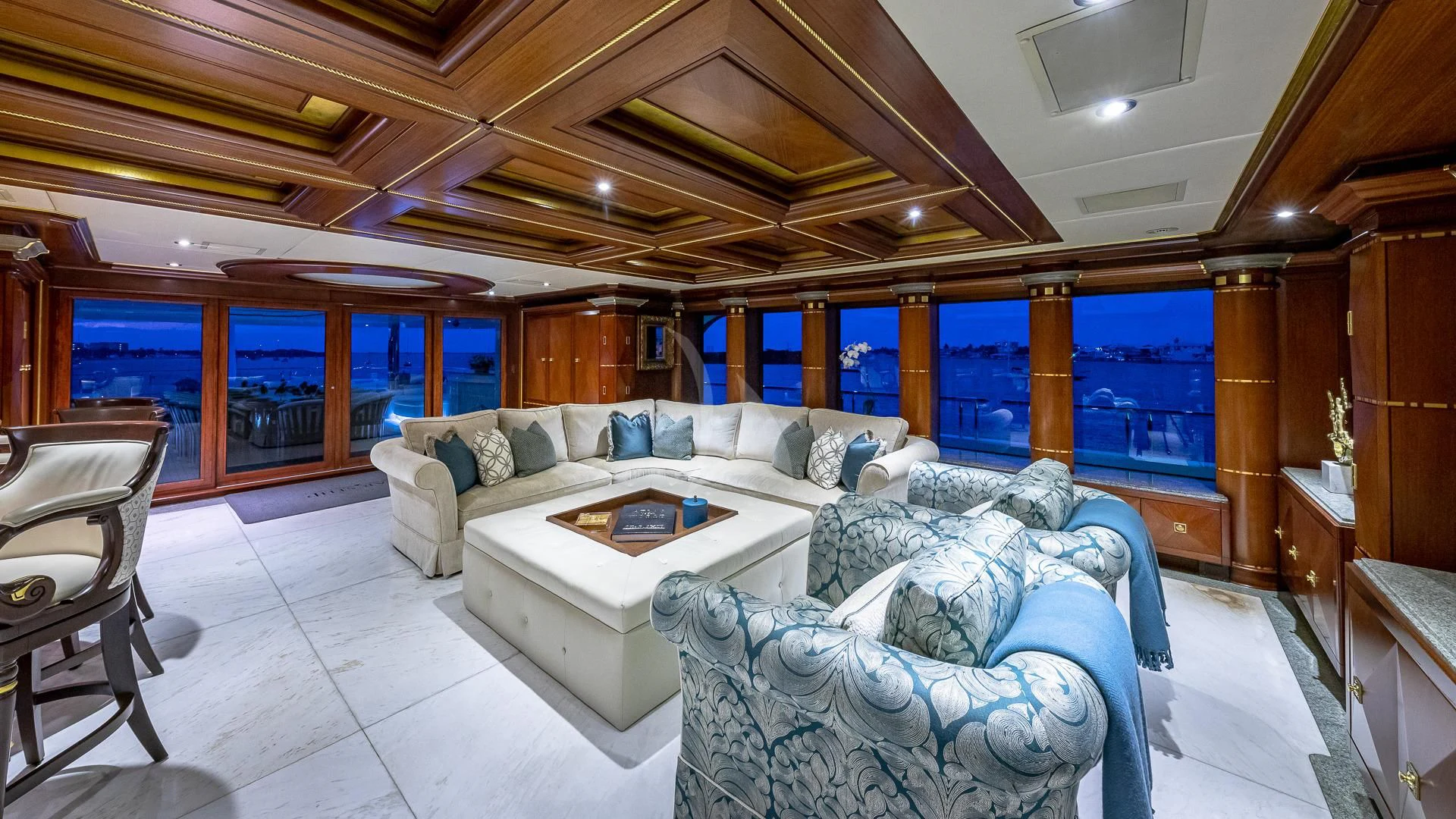 a living room with a couch and a table aboard STARSHIP Yacht for Charter