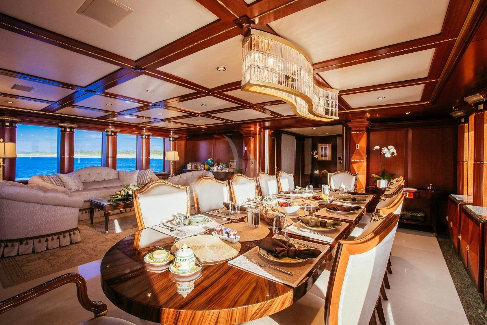a large room with a table and chairs aboard STARSHIP Yacht for Charter