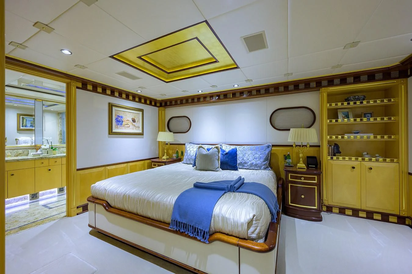 a bedroom with a bed and a desk aboard STARSHIP Yacht for Charter