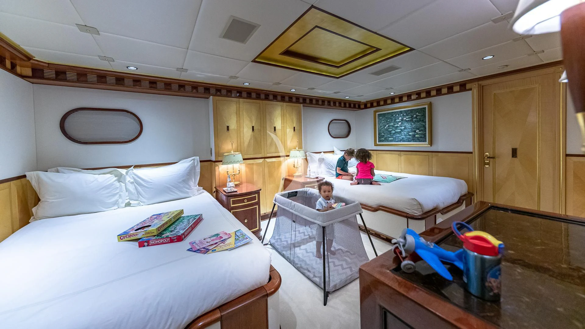 a couple of kids in a bedroom aboard STARSHIP Yacht for Charter