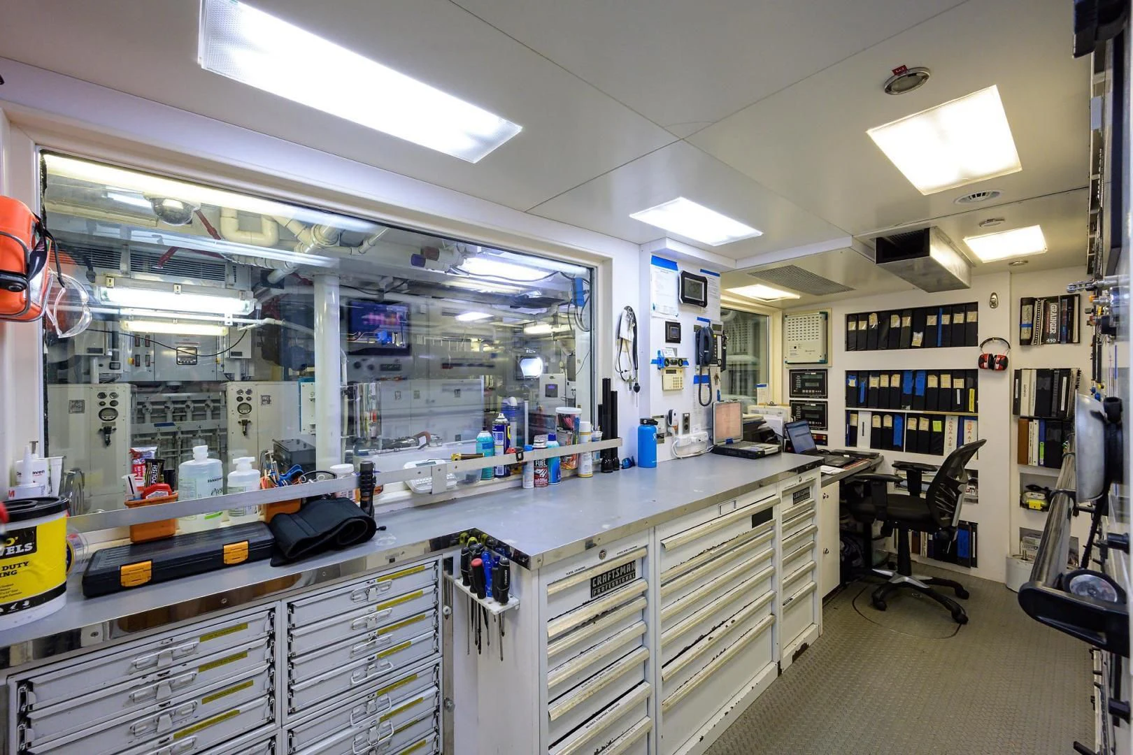 a room with shelves and a chair aboard STARSHIP Yacht for Charter