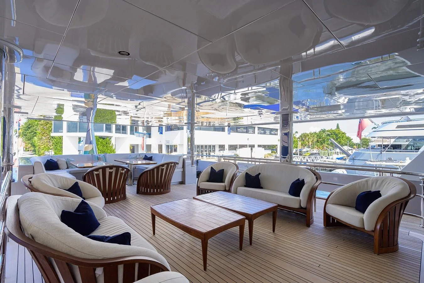 a room with a table chairs and a view of the water aboard STARSHIP Yacht for Charter