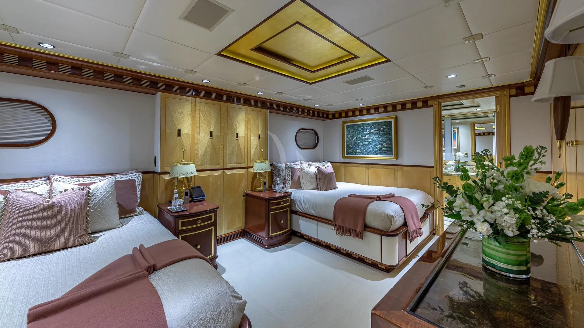 a room with a bed and a table aboard STARSHIP Yacht for Charter