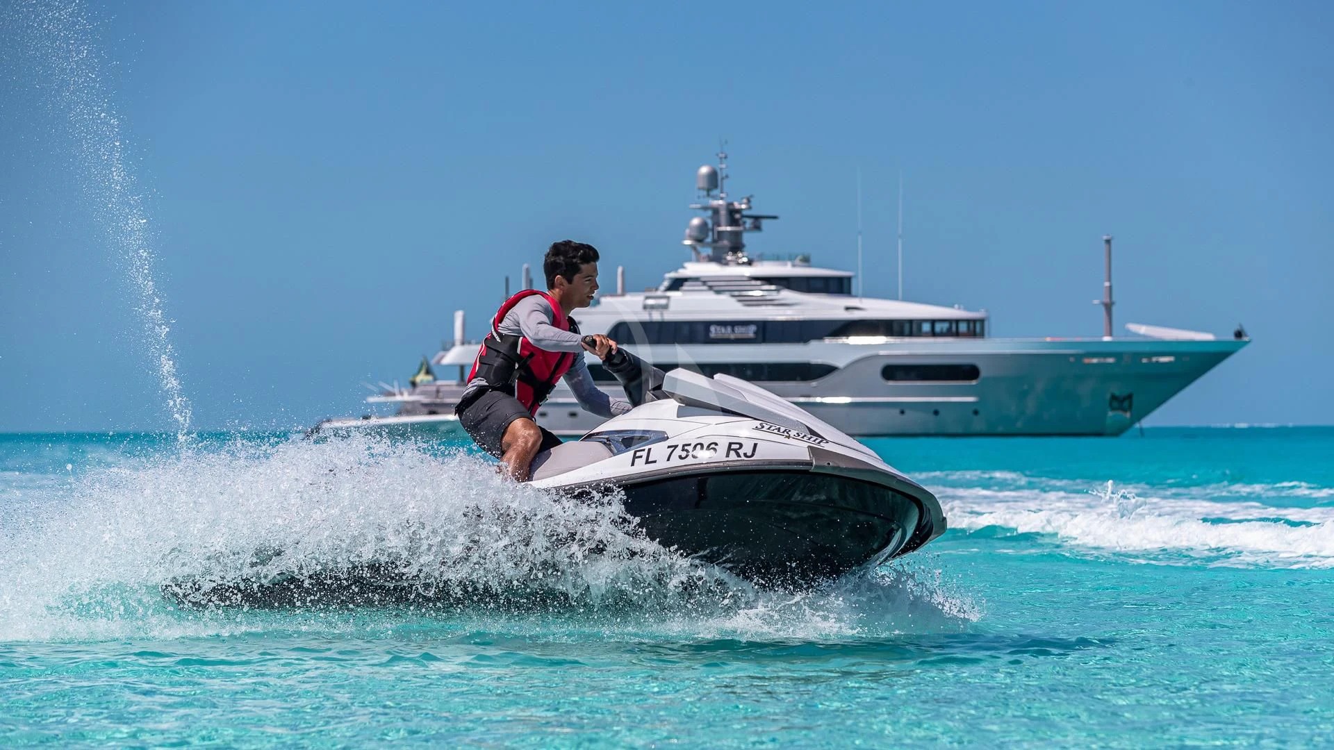 a man jumping out of a boat aboard STARSHIP Yacht for Charter