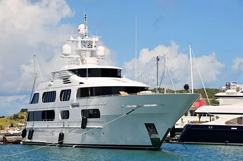 a large white boat in the water aboard STARSHIP Yacht for Charter