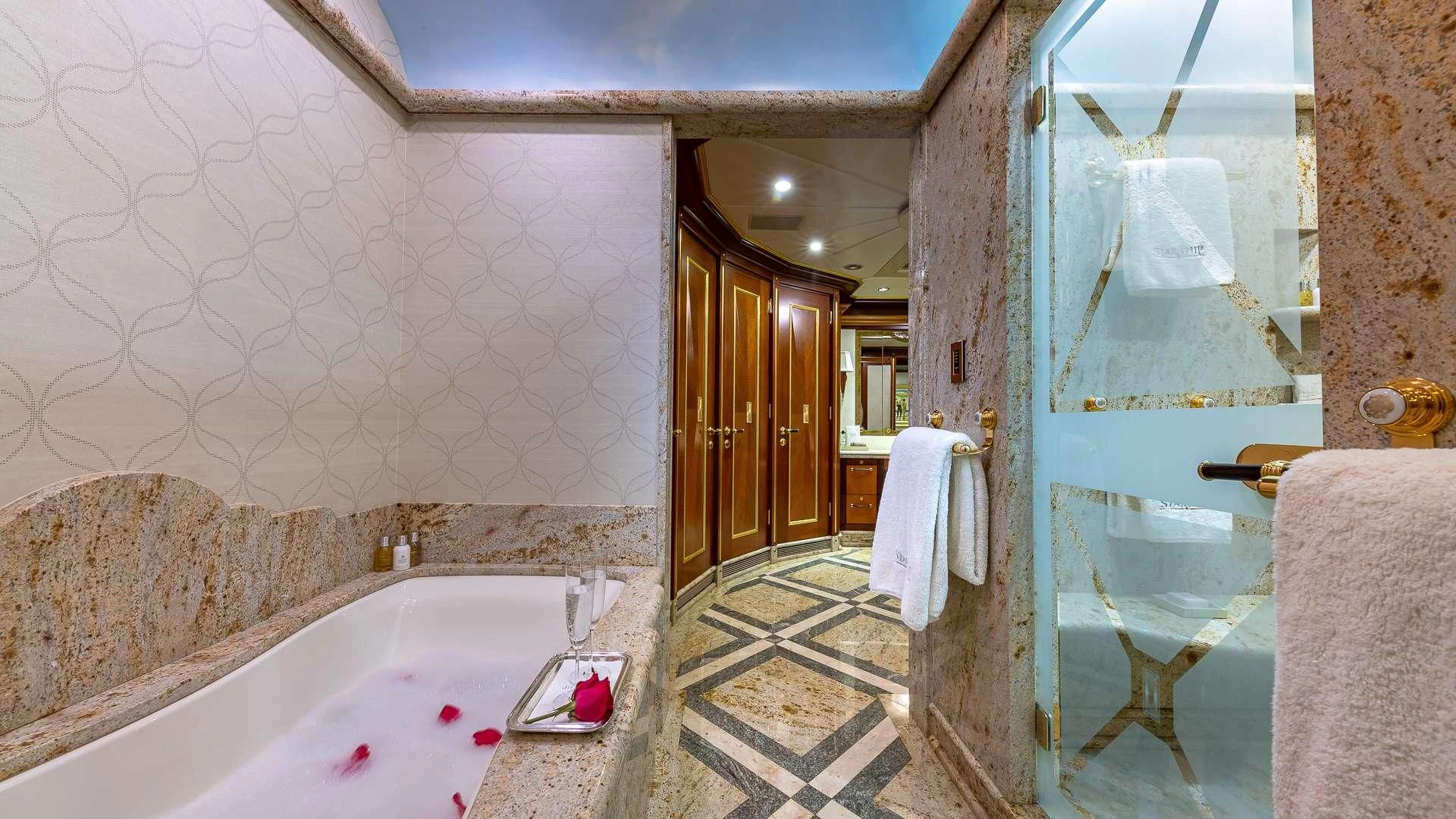 a bathroom with a tub and shower aboard STARSHIP Yacht for Charter