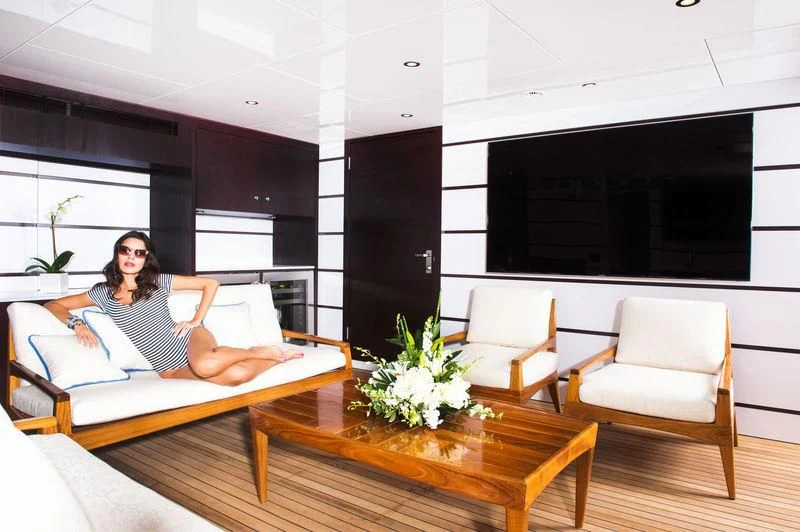 a person sitting on a couch aboard STARSHIP Yacht for Charter