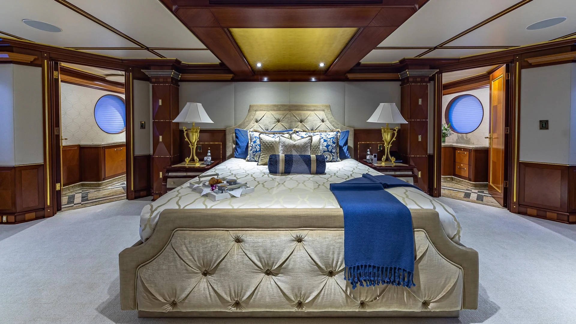 a room with a bed and a mirror aboard STARSHIP Yacht for Charter