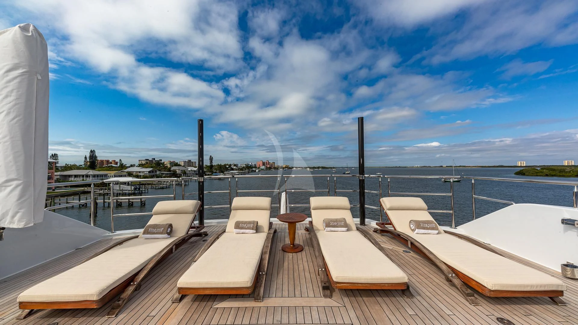 a deck with chairs and tables on it aboard STARSHIP Yacht for Charter