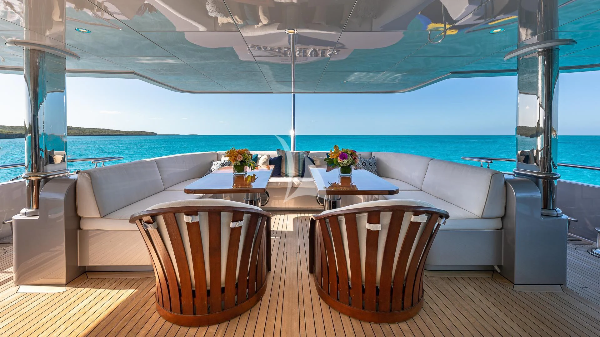 a room with a table and chairs aboard STARSHIP Yacht for Charter