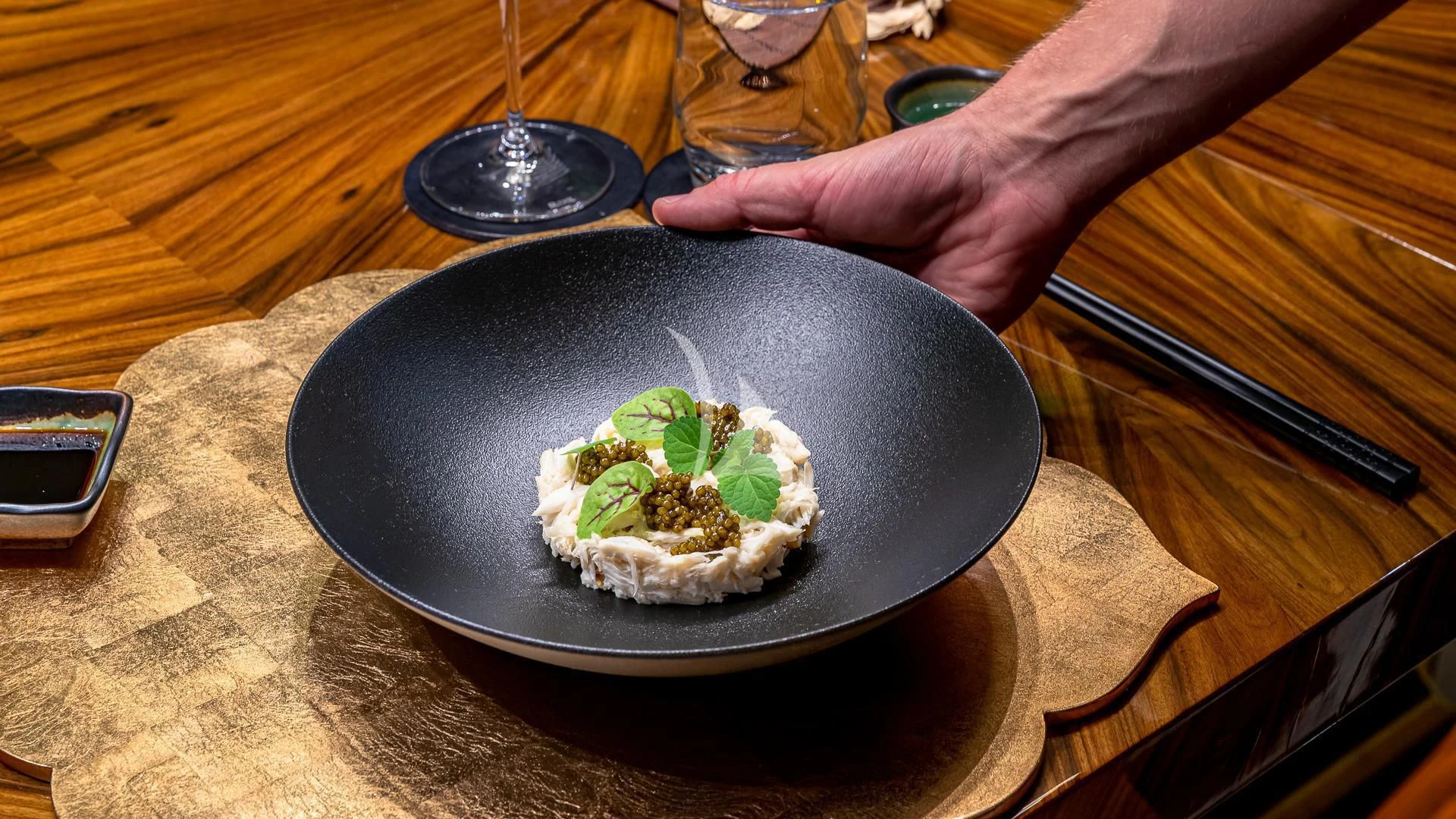a person holding a plate of food aboard STARSHIP Yacht for Charter