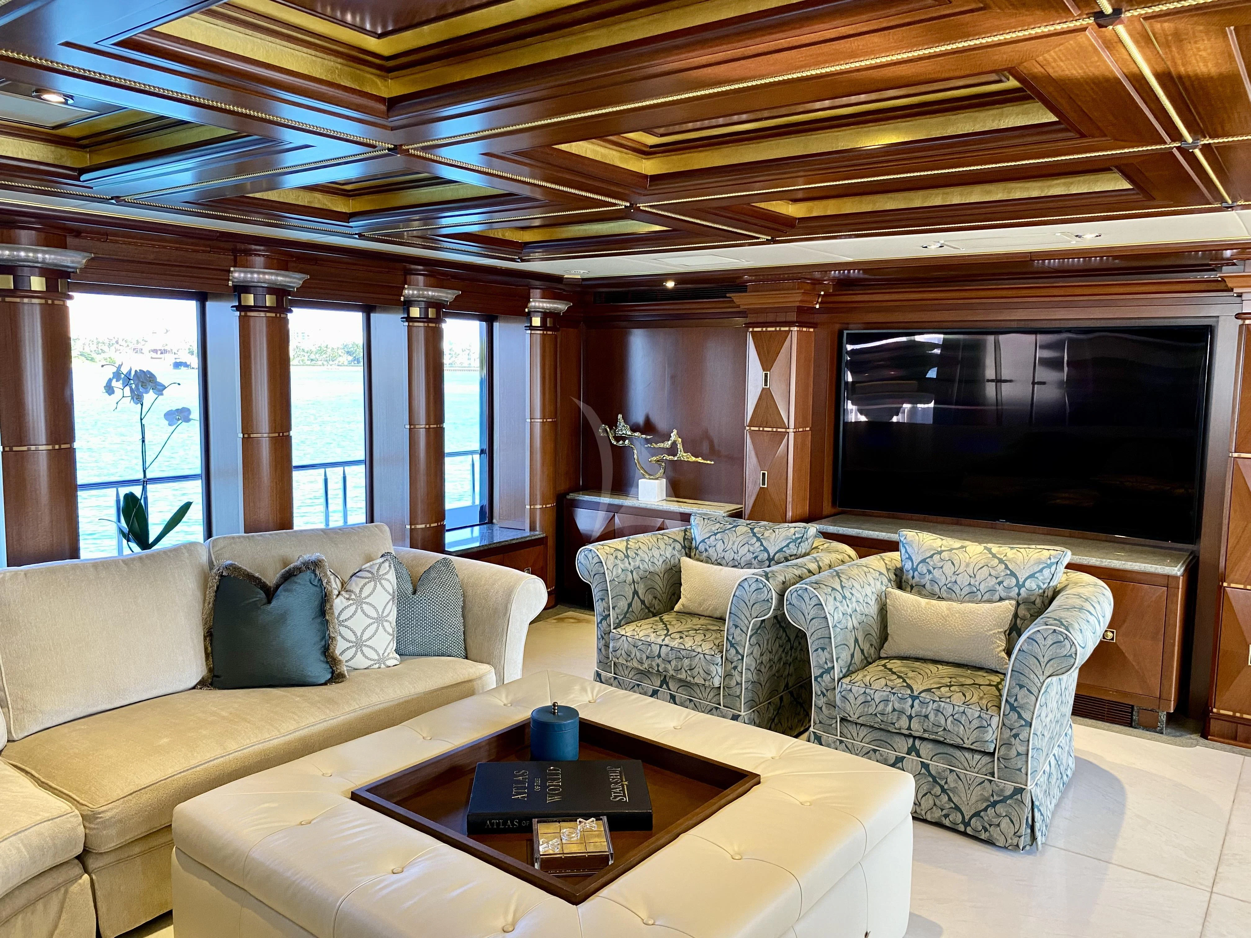 a living room with a large screen aboard STARSHIP Yacht for Charter