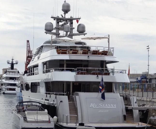 a large white boat with flags on it aboard STARSHIP Yacht for Charter