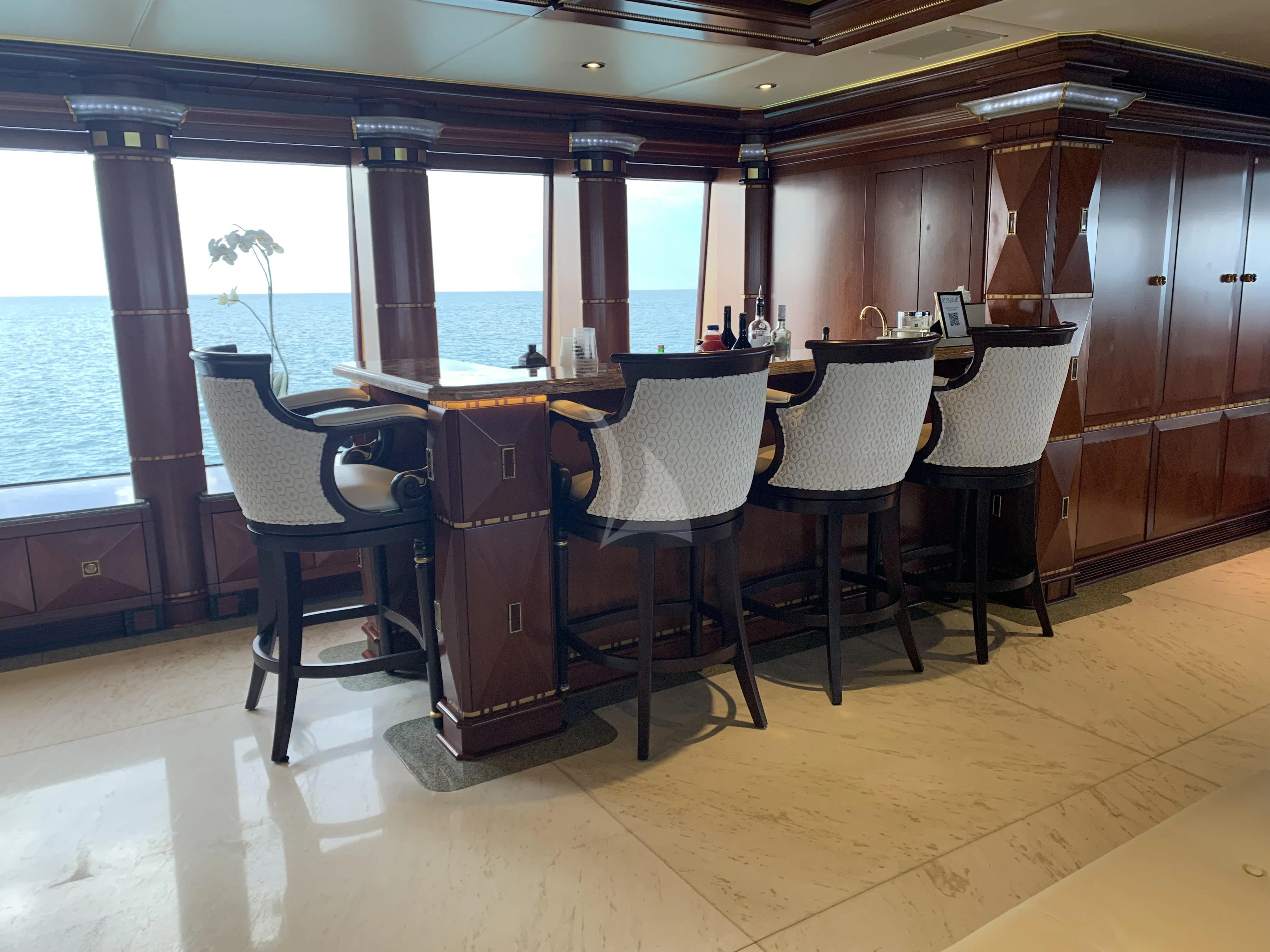 a room with a table and chairs aboard STARSHIP Yacht for Charter