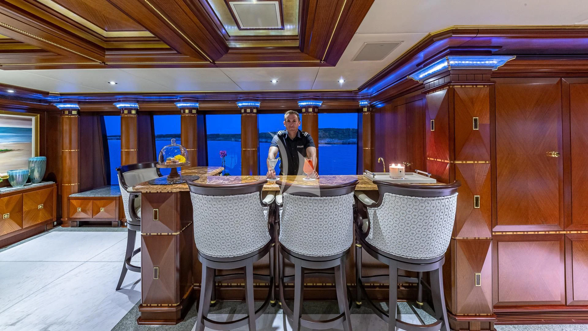 a person standing at a table aboard STARSHIP Yacht for Charter