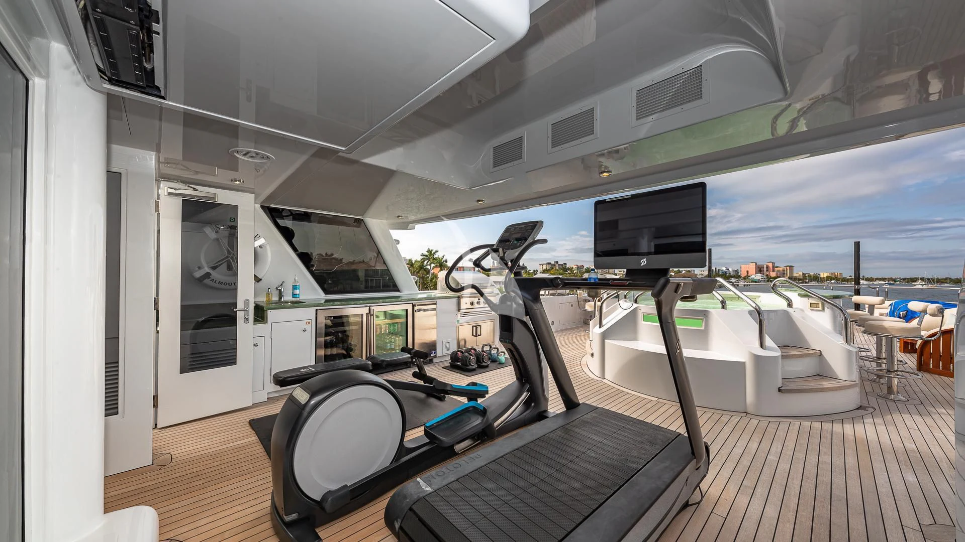a room with a large window and a desk with a computer and a large window aboard STARSHIP Yacht for Charter