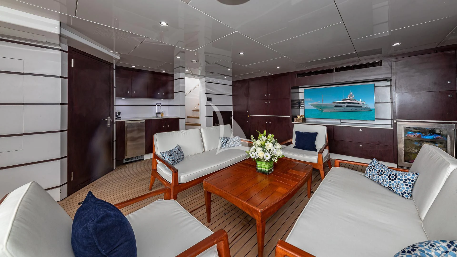 a living room with a couch and a tv aboard STARSHIP Yacht for Charter