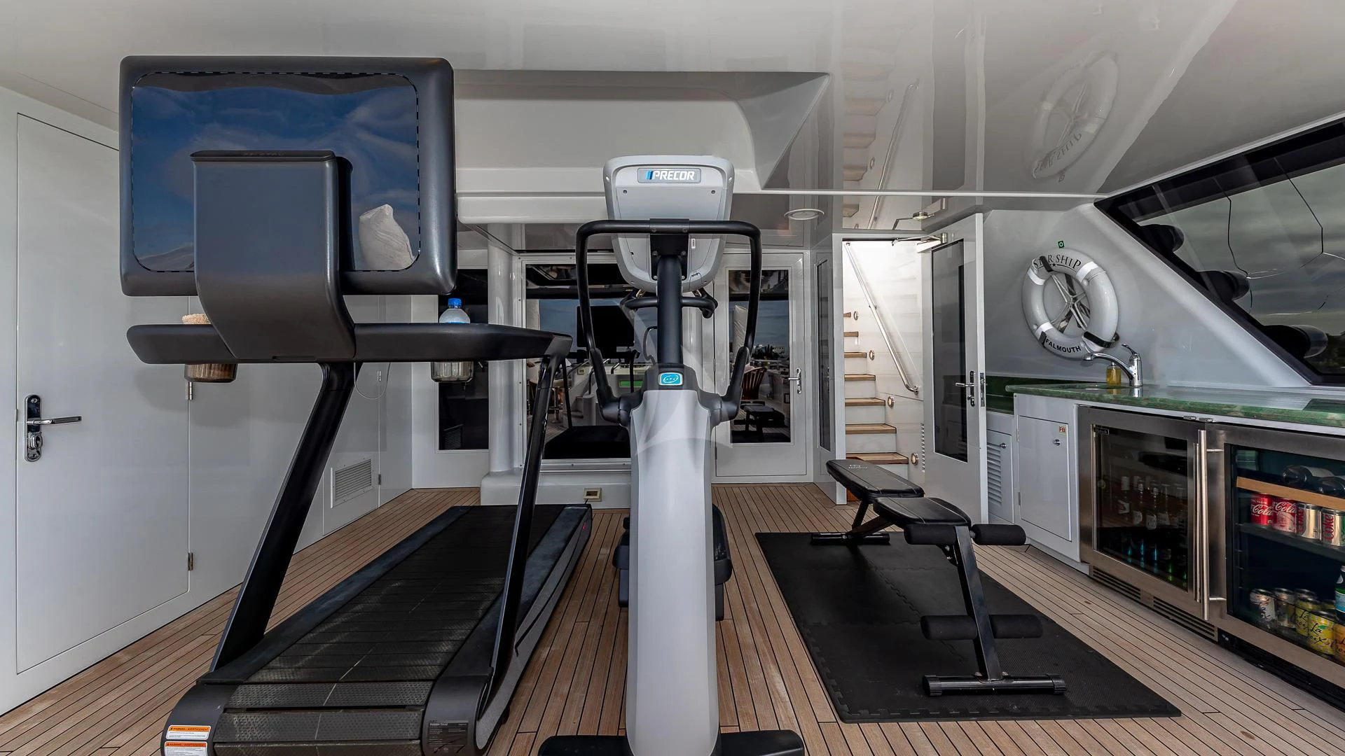 a treadmill in a room aboard STARSHIP Yacht for Charter