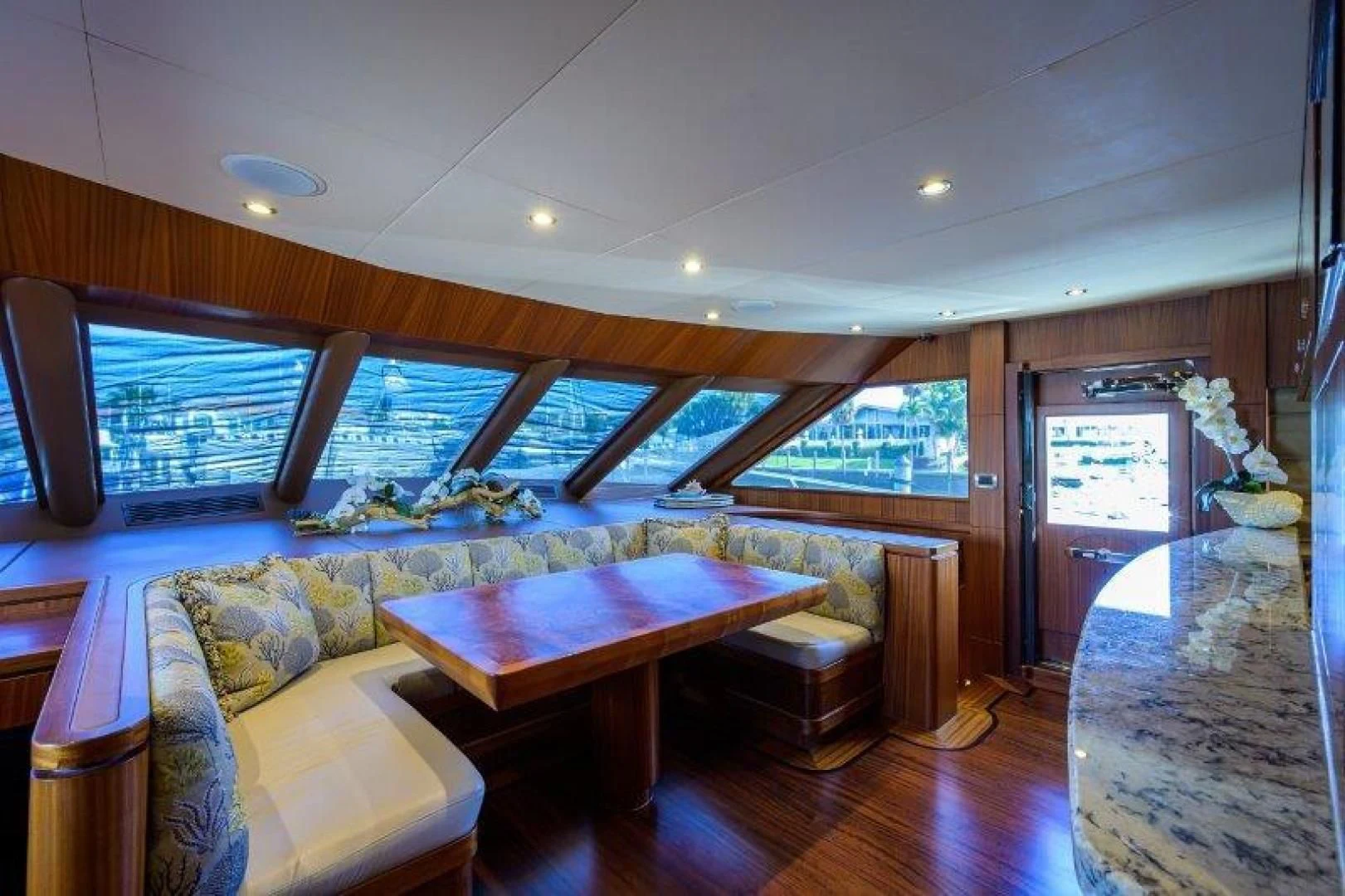 a room with a pool table and couches aboard SOUNDINGS Yacht for Sale